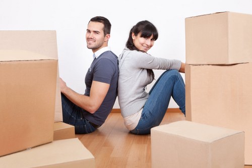 Local movers preparing a van for loading in a residential street