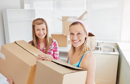 Removal professionals handling office items in a North London commercial move