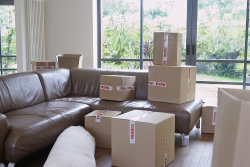 Home removal team handling furniture in a Fortis Green property