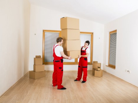Removal helper carrying furniture near Fortis Green homes